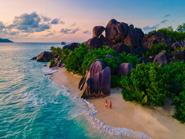 istock Anse Source d'Argent beach, La Digue Island, Seyshelles, Drone aerial view of La Digue Seychelles bird eye view, couple men and woman walking at the beach during sunset at a luxury vacation 1477004236