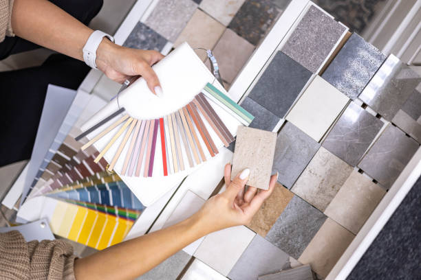 istock Woman architect designer select epoxy grout ceramic tiles compare samples finishing works concept 1477008233