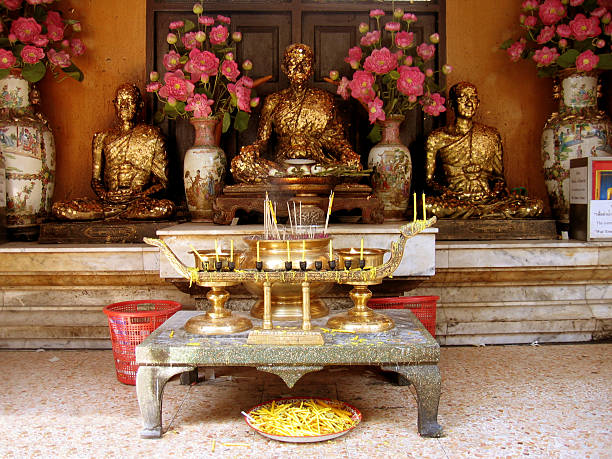 Golden Buddha Alter Golden Buddha Alter with incense and burning candles trishz stock pictures, royalty-free photos & images