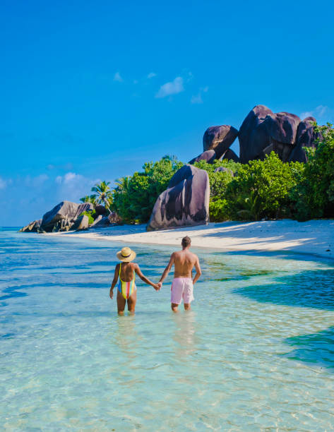 istock Anse Source d'Argent beach, La Digue Island, Seyshelles, Drone aerial view of La Digue Seychelles bird eye view, couple men and woman walking at the beach during sunset at a luxury vacation 1477024057