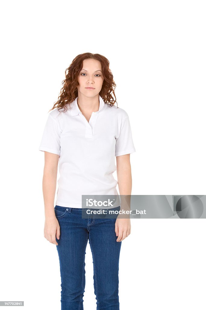 Young redhead woman in white polo shirt and jeans Fashion model in white t-shirt and blue jeans Polo Shirt Stock Photo