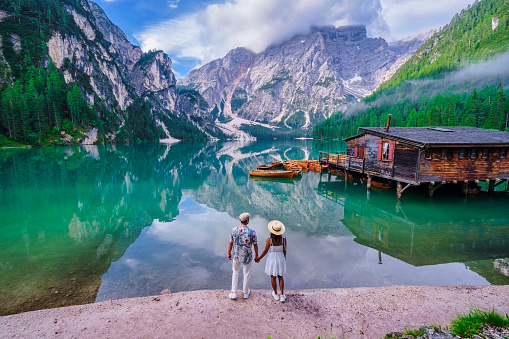 Couple of men and women at Lago Di Braies Italy, Pragser Wildsee in South Tyrol, Beautiful lake in the Italian alps, Lago di Braies. vacation Italian alps mountain lake