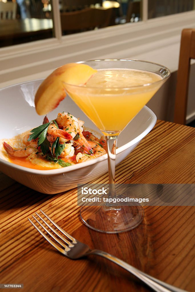 Glass of Wine with Shrimp Dish A bowl of shrimp with a refreshing glass of peach wine. Alcohol - Drink Stock Photo