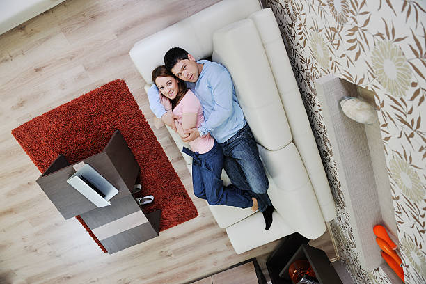 istock happy young couple relaxing at home 147703387