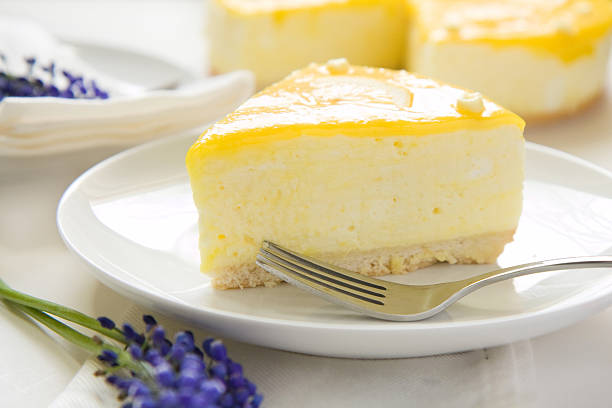 A picture of a slice of lemon mousse cake Lemon Mousse topped with a fresh and tangy lemon curd grape hyacinth photos stock pictures, royalty-free photos & images