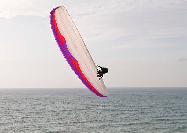 istock Paraglider diving toward the sea 147703801