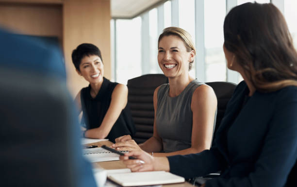 Business women in happy meeting for corporate planning, speaking of company goals and staff update in conference room. Professional manager, boss or people agenda for employees discussion or proposal stock photo