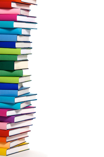 Stack of colorful real books on white background, partial view.