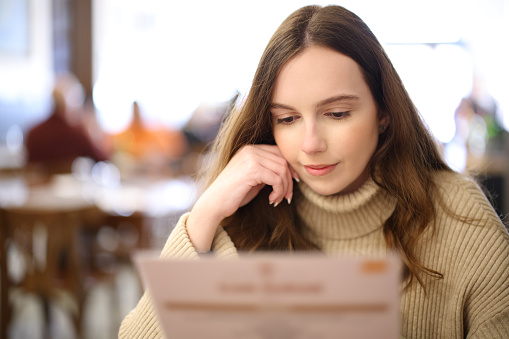 Woman reading menu in a restaurant