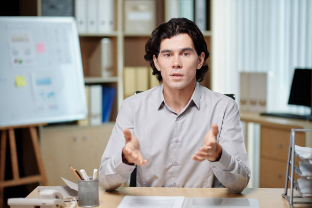 istock Young confident male business coach explaining something at seminar 1477041795