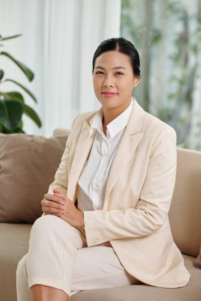 istock Young smiling brunette female entrepreneur sitting on couch 1477041896