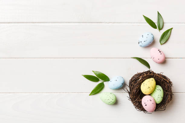 istock Colorful easter eggs in nest on table background with copy space top view 1477044397