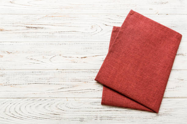 top view with red empty kitchen napkin isolated on table background. Folded cloth for mockup with copy space, Flat lay. Minimal style