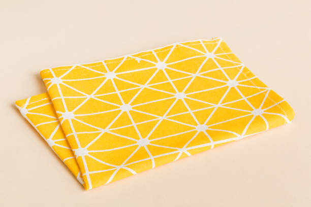 istock top view with yellow empty kitchen napkin isolated on table background. Folded cloth for mockup with copy space, Flat lay. Minimal style 1477044452