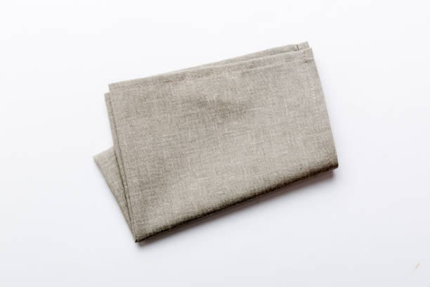 istock top view with gray kitchen napkin isolated on table background. Folded cloth for mockup with copy space, Flat lay. Minimal style 1477044454
