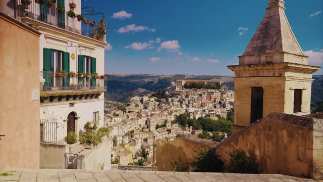 Bell tower and cityscape against sky at ancient Ragusa Ibla , Sicily, Italy