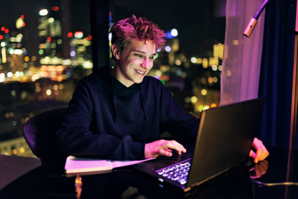 Teenage boy doing homework late at night