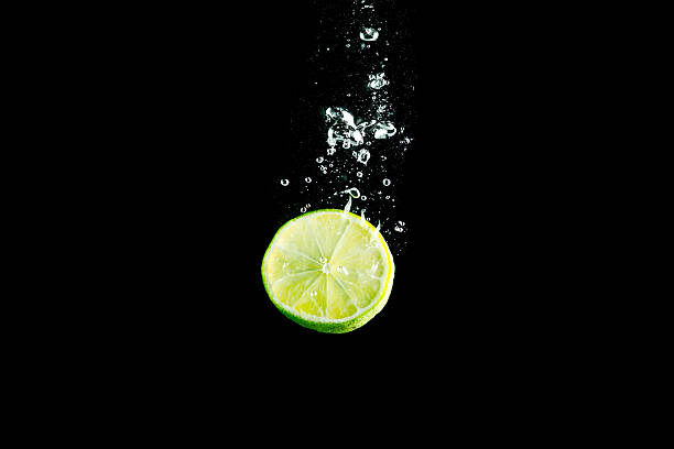 istock Slice of lime splashing in water 147704524