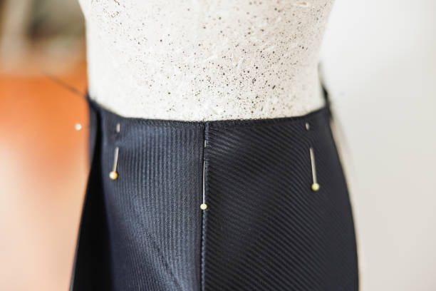 Sewing pins holding pants waist, fitting in small business tailor salon