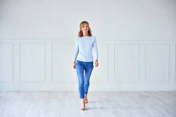 Mature woman, real estate agent portrait and empty house of a real estate worker with new property. Happy, home and mortgage of a older female agent with a smile in a living room with happiness from work