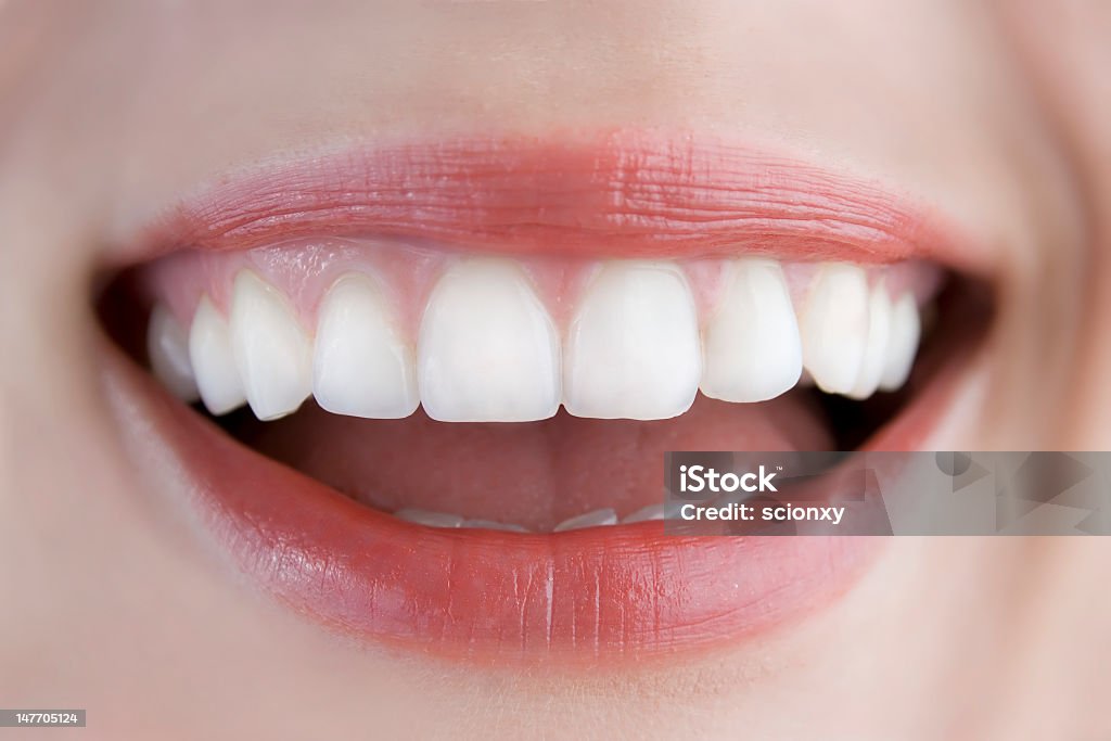 Close-up of nice white teeth surrounded by pink lips white teeth closeup, woman smiling Close-up Stock Photo