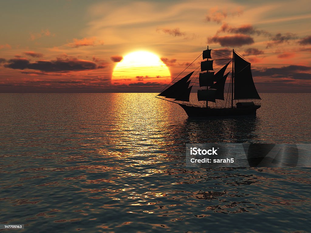 Ship out at sea during sunset. An old merchant ship out at sea at sunset. Dusk Stock Photo