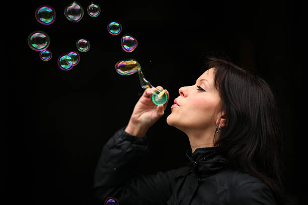 istock Young woman blowing bubbles 147705262