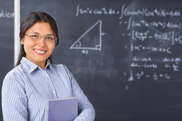 istock Teacher or scholar pose in front of blackboard 147705273
