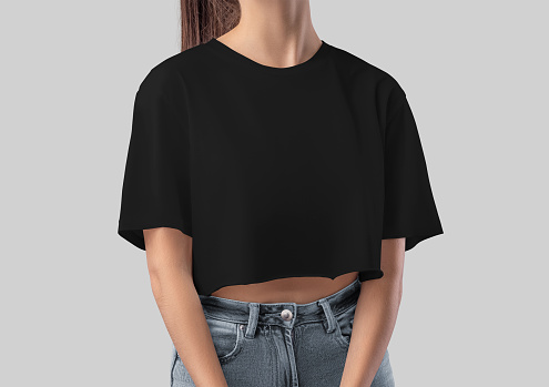 Black crop top mockup on slim girl, blank canvas bella shirt, front view, for design, print, advertising. Fashion blank t-shirt template isolated on background. Women's apparel close-up