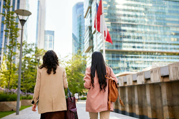 istock Businesswomen walking together in downtown district 1477054408
