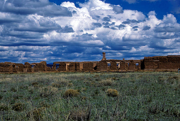 Fort Union ruins under gorgeous clouds, circa 1987 Fort Union ruins. Lots of copy space in the foreground/grass, and in the sky. hearkencreative stock pictures, royalty-free photos & images