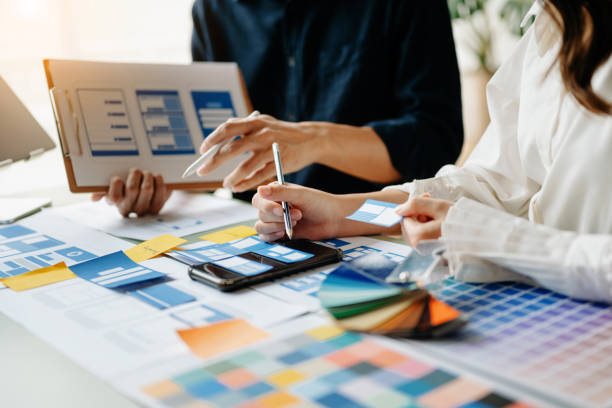 istock View of UI developer team brainstorming on their project with laptop, smartphone and digital tablet. Creative digital development agency. 1477056497