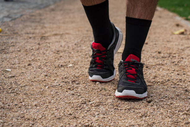 istock Men running feet with sport shoes. 1477058323