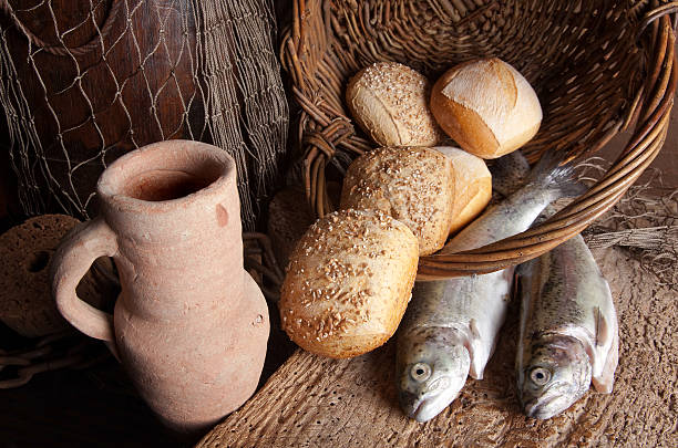 Wine jug with bread and fish Vintage still life of an old wine jug with bread loaves and fresh fish galilee photos stock pictures, royalty-free photos & images