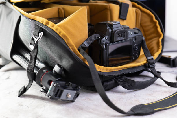 istock Stylish Camera Bag with Accessories on Grey Table. Professional Camera Equipment. 1477061019