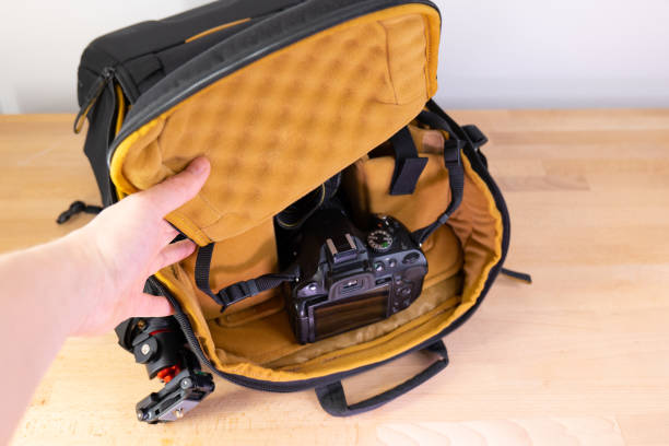istock Man packing camera lens to his bag. 1477061213