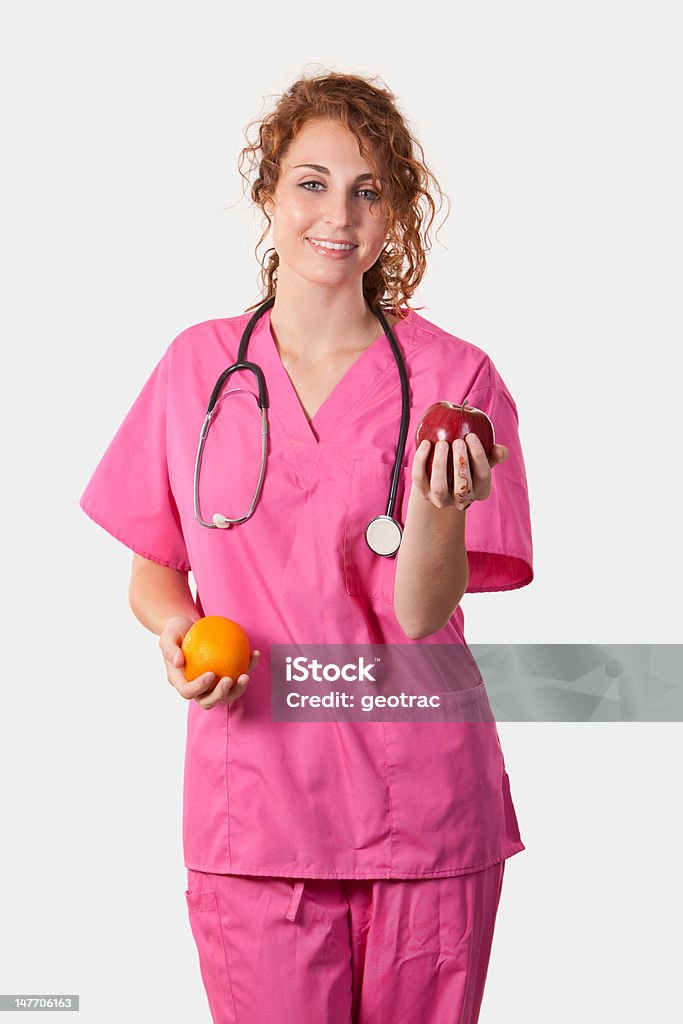 Медсестра с фруктами - Стоковые фото Апельсин роялти-фри