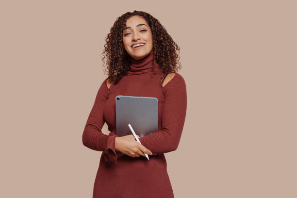 istock Young cheerful arabic businesswoman works using digital tablet 1477062768