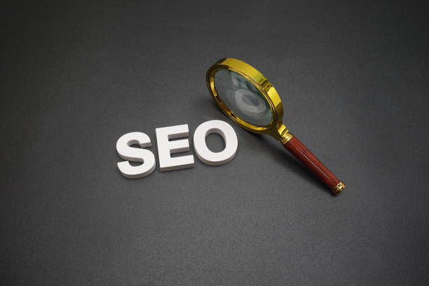istock SEO (search engine optimization) text message with magnifying glass on black background 1477063353