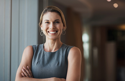Business woman, portrait and smile with arms crossed in leadership, manager or motivation in Canada. Happy female executive, corporate pride and empowerment of management, commitment or employee face