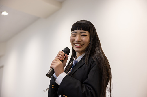 High school girl singing a song - looking at camera