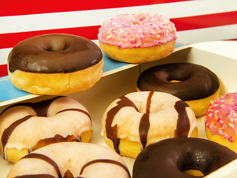An assortment of delectable miniature doughnuts, coated with chocolate and colorful frosting