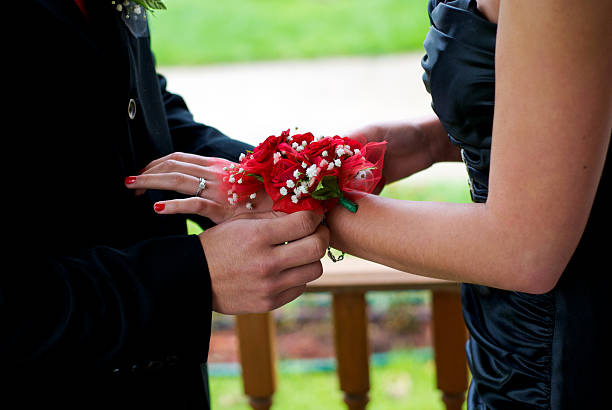 istock A man applying a corsage to a woman's wrist 147706889
