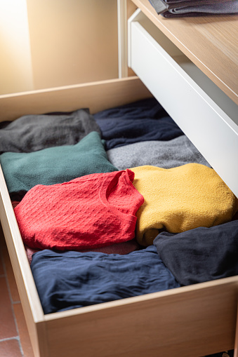 colorful sweaters in drawer