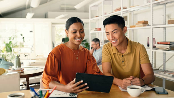 istock Tablet, planning and startup people in workspace meeting for digital collaboration, diversity teamwork and strategy. Woman talking to business partner, employee or clients on technology for research 1477074693