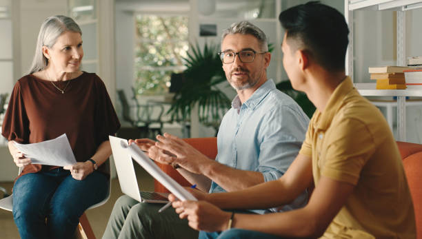 istock Startup meeting, teamwork discussion and documents with proposal, planning and strategy for company vision. Leader, presentation and diversity with paper for workshop, ideas and report in negotiation 1477074702
