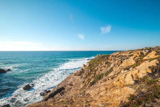 istock Breathtaking cliffs with pebble beach in the afternoon sun on the Atlantic coast at Vila Nova de Milfontes, Odemira, Portugal. In the footsteps of Rota Vicentina. Fisherman trail 1477076219