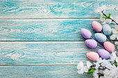Easter eggs on a blue background on top. Copy space