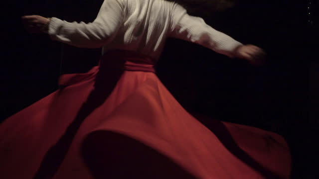 Whirling Dervish performing Sufi dance in the spotlight