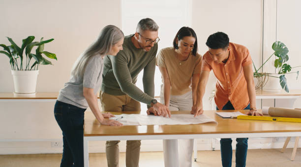 istock Strategy, data analytics or business people in meeting planning a startup project in collaboration together. Teamwork, brainstorming ideas or workers with paperwork for our vision, sales or b2b goals 1477078599